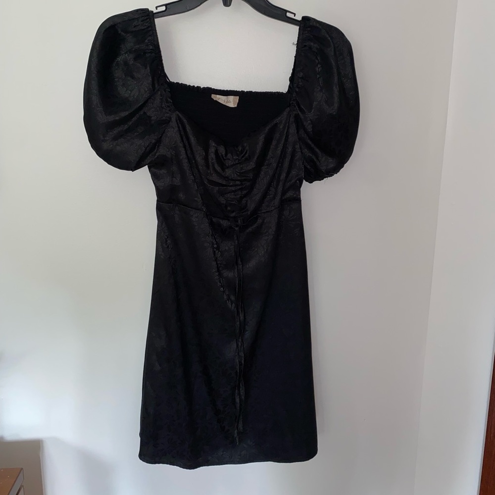 Black mini dress with open back and puffed sleeves